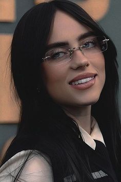 a woman with long black hair wearing glasses