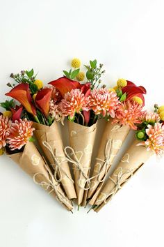 a bunch of flowers are wrapped in brown paper