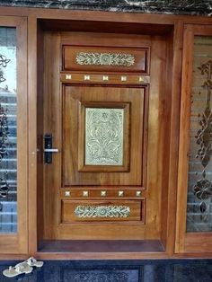 an ornate wooden door with glass panels