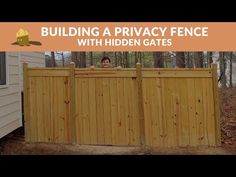 a wooden fence in front of a brick house