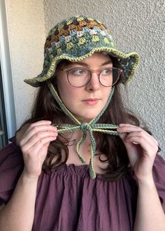 a woman with glasses and a hat on her head