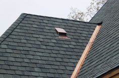 an image of a roof that has a window in the middle and shingles on it