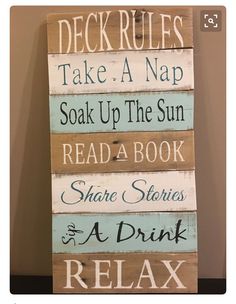 a wooden sign that says rules take a nap soak up the sun read a book share stories and a drink relax