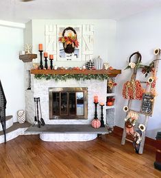 a living room filled with furniture and a fire place in the middle of a wooden floor