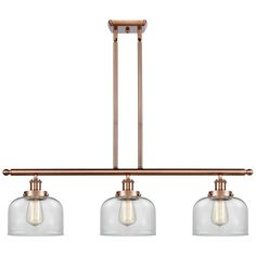 three light pendant fixture with clear glass shades on the bottom and an antique brass finish