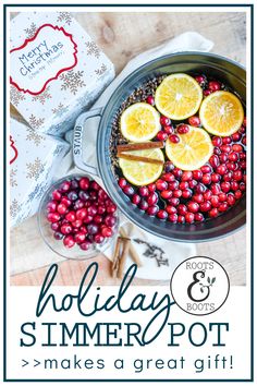 a pot filled with cranberries and lemons on top of a wooden table