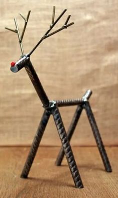 a metal deer made out of sticks and nails