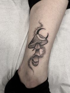 a black and white mushroom tattoo on the leg