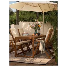 a wooden table with chairs and an umbrella