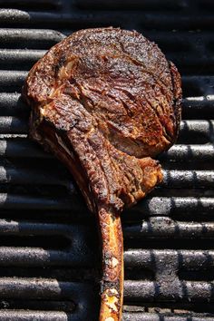 a piece of meat is being cooked on a grill