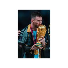 a man holding a soccer ball in his hand and wearing a jacket with the world cup on it