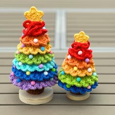 two small crocheted christmas trees sitting on top of each other