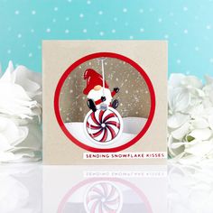 a christmas card with a snowflake kiss on it's face and candy cane in the background