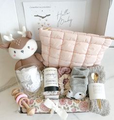 the baby hamper is packed with items for it's newborn girl to be