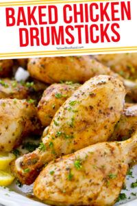 baked chicken drumsticks on a plate with lemon wedges