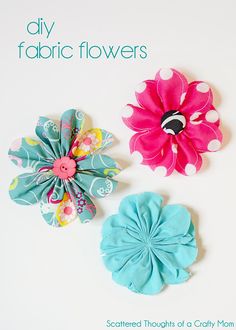 three different colored flower hair clips on a white surface with the words scattered thought of a crafty mom