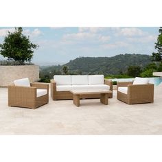 an outdoor patio furniture set with white cushions