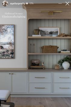 a living room with built in bookshelves and cabinets