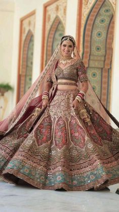 a woman in a bridal gown poses for the camera