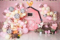 a pink and white farm themed birthday party with balloons, decorations and animals on the floor