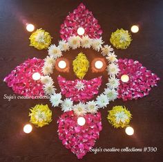 a decorated diya with lit candles and flowers