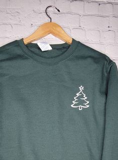 Minimal Christmas Sweatshirt is perfect gifts It is gifts idea for holiday and ideal for any situation. These sweatshirts are a mid-weight and super soft on the inside!! They are 80% cotton 20% polyester! Hoodies are embroidered on my commercial embroidery machine. They ship within 10 business days and take an additional 3-5 days to arrive. If you need them sooner please let me know! Winter Crew Neck T-shirt Relaxed Fit, Winter Relaxed Fit Crew Neck T-shirt, Relaxed Fit Crew Neck T-shirt For Winter, Christmas Crew Neck Cotton Sweater, Christmas Cotton Crew Neck Sweater, Casual Christmas Crew Sweatshirt, Casual Christmas Crew Neck Sweatshirt, Holiday Green Cotton Sweatshirt, Green Cotton Holiday Sweatshirt