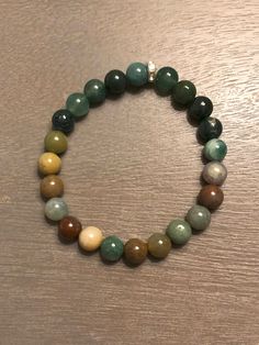 Embrace the beauty of the natural world with our Indian & Green Moss Bead Bracelet, a tribute to the elegance of the natural gems. Crafted with care and attention to detail, whether you're a fan of minimalist chic or you prefer bold, statement pieces, our nature-inspired bracelets offer an array of choices. Wearing this bracelet is like carrying a piece of nature's serenity with you, allowing you to express your love for the world around us and your unique style simultaneously. Perfect for both Spiritual Agate Beaded Bracelets For Healing, Holistic Agate Beaded Bracelets For Healing, Spiritual Agate Beaded Bracelet With 8mm Beads, Adjustable Agate Beaded Bracelets In Holistic Style, Adjustable Agate Beaded Bracelets, Agate Gemstone Beaded Bracelets For Healing, Casual Agate Bracelet With Natural Stones, Spiritual Aventurine Bracelets With Natural Stones, Casual Agate Bracelets With Natural Stones