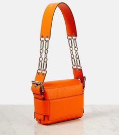 Find ACNE STUDIOS Musubi Leather Shoulder Bag on Editorialist. The Acne Studios Musubi leather shoulder bag is crafted in Italy from textured leather. The bag features a knotted detail, a detachable chain and leather shoulder strap, and an internal card slot. It closes with a slot-tab fastening and comes with a dust bag. Orange Rectangular Shoulder Bag With Detachable Strap, Orange Leather Shoulder Bag With Palladium Hardware, Acne Musubi Bag, Acne Studios Bag Musubi, Orange Textured Leather Shoulder Bag, Acne Studios Wallet, Acne Studios Bag, Acne Shop, Orange Bag