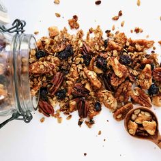 granola mix in a glass jar next to a spoon