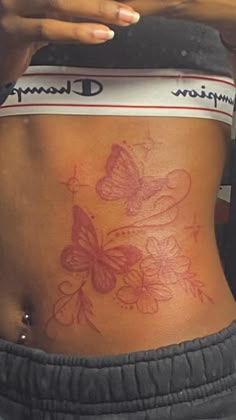 a woman's stomach with butterfly tattoos on her side and the word champion written in white ink