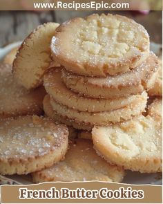 a pile of cookies sitting on top of a white plate with the words french butter cookies