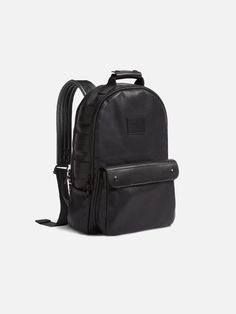 a black backpack with straps on the front and back pocket, sitting against a white background