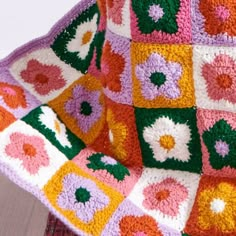 a crocheted blanket with flowers on it