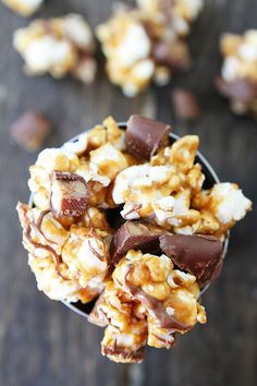 a bowl filled with chocolate covered popcorn and marshmallows