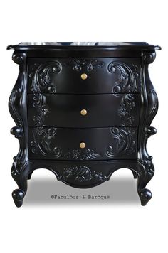 an ornate black chest of drawers with gold knobs on the top and bottom drawer