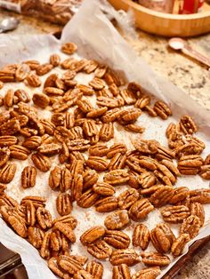 a tray filled with lots of pecans sitting on top of a counter