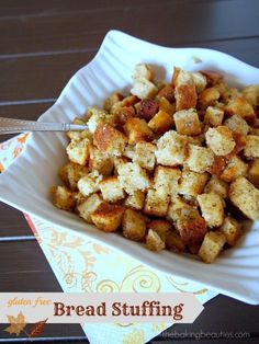 a white bowl filled with bread stuffing on top of a table