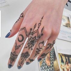 a woman's hand with tattoos on it