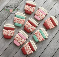 decorated cookies are arranged on a wooden table