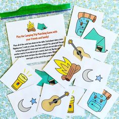 four children's cards with pictures of camping themed items on them, including an umbrella and tent