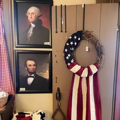 a patriotic wreath is hanging on the wall next to two framed pictures and a pair of scissors