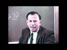 an old photo of a man in front of a chalkboard