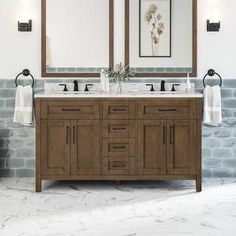 a bathroom with two sinks and mirrors on the wall next to each other in front of a brick wall