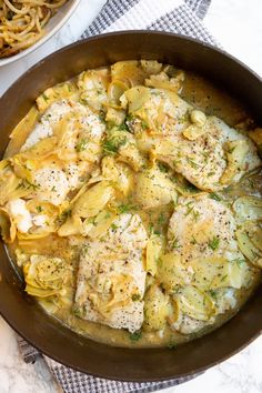 a pan filled with pasta and chicken covered in sauce