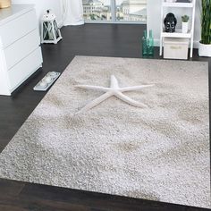 a white rug with a starfish on it in the middle of a living room