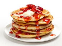 the cover of food network magazine with pancakes and strawberries on it's plate