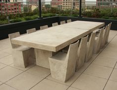 an outdoor table and benches on a patio