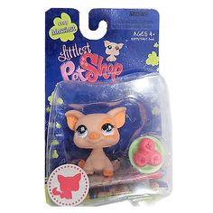 littlest pet shop figurine with pink hair and blue eyes, in packaging