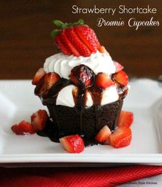 strawberry shortcake brownie cupcakes with chocolate frosting and strawberries on top