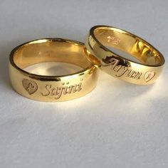 two gold wedding rings that say i love you and sagitrobit on them